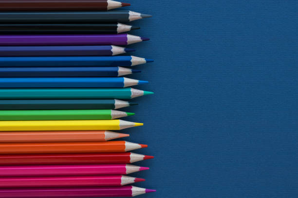 istock vertical row of multicolored pencils on dark blue background. 1270305285
