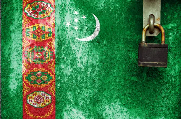 Photo of Flag of Turkmenistan is on texture. Template. Coronavirus pandemic. Countries may be closed. Locks.