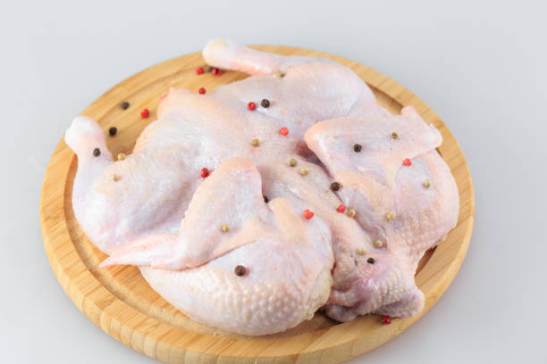 istock Raw chicken carcass on the cutting board isolated on white background. 1270309759