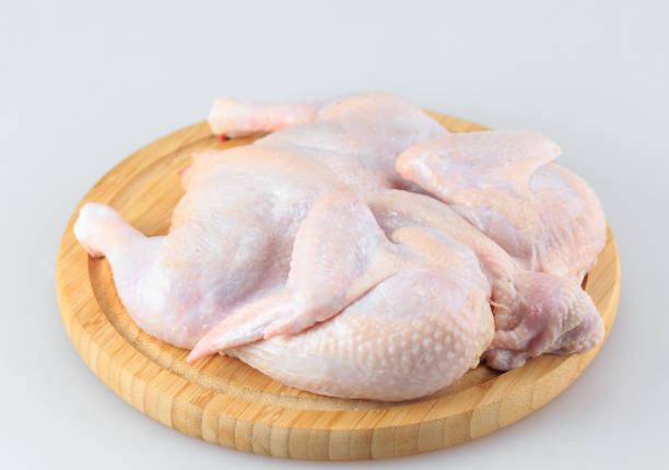istock Raw chicken carcass on the cutting board isolated on white background. 1270309775