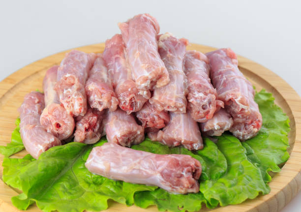 istock Chicken neck on a wooden board on white background. 1270309787