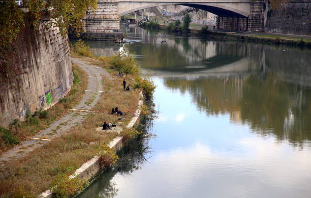 Fishing into the city river, Rome, Italy