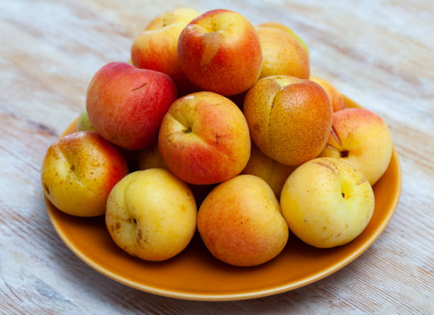 istock Fresh ripe apricots on wooden table 1270310400