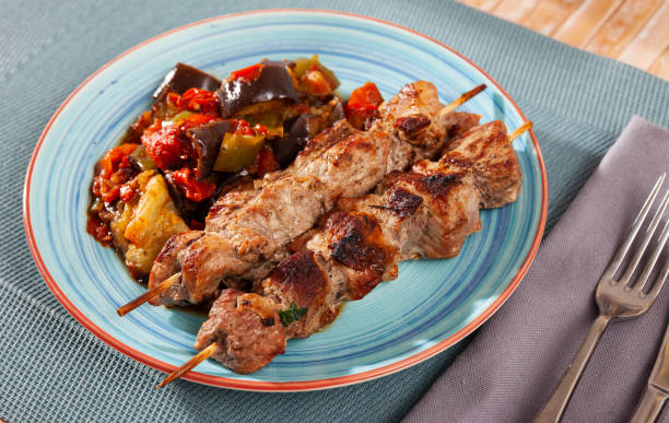 istock Grilled pork meat shashlik with sauteed vegetables 1270310471