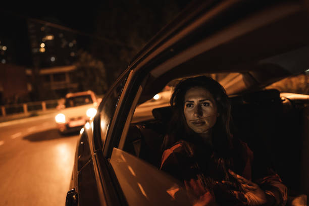 istock Woman sitting on back seat and looking through window 1270313204