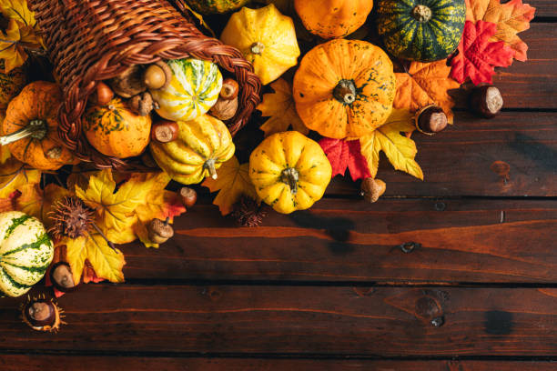 istock Decorated Autumn Thanksgiving Cornucopia on a wooden background 1270315826