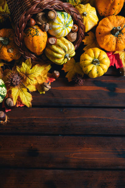 istock Decorated Autumn Thanksgiving Cornucopia on a wooden background 1270315827