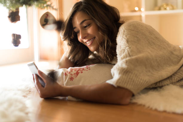 istock Woman using a smartphone at home 1270315845