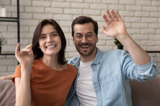 istock Smiling couple greet talking on video call at home 1270316180