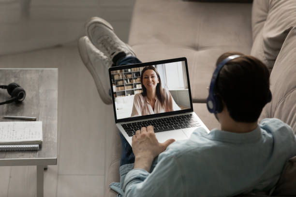 istock Back view of man talk on webcam conference with woman 1270316218