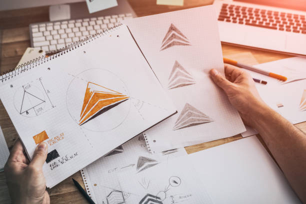 istock Graphic designer drawing sketches logo design. 1270316406