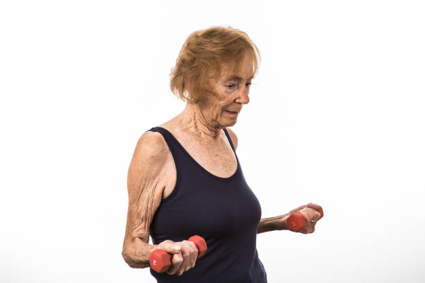 istock Senior Woman Concentrates On Lifting Two Pound Dumbbells 1270316953