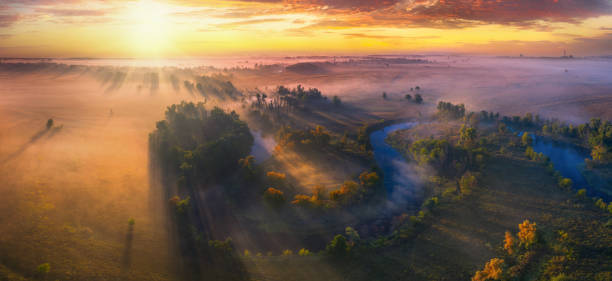 istock Mystical morning river, the sun's rays shine through the fog. 1270317103