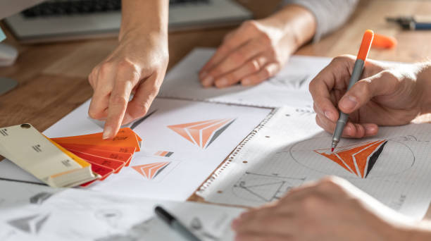 istock Graphic designer drawing sketches logo design. 1270317105