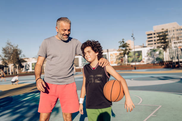 istock Father and son having fun after basketball training 1270320233