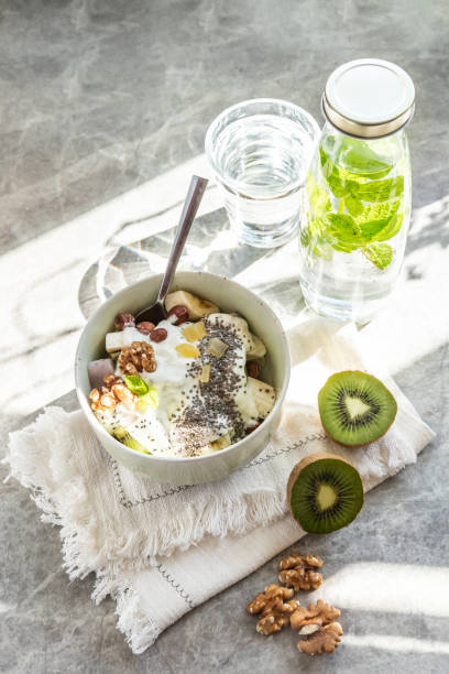 istock Fruit salad with yogurt in a bowl served for breakfast in sunlight 1270323117
