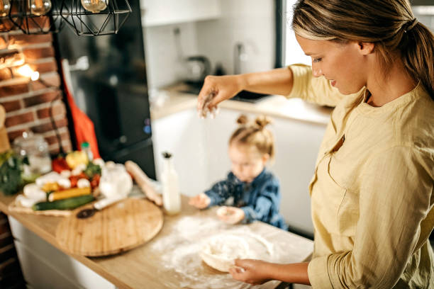 istock Mother and daughter making pizza at home 1270327915
