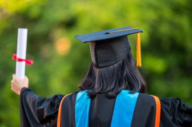 istock Back view of a female graduate with a university degree 1270333541