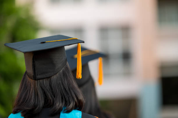istock Back view of a female graduate with a university degree 1270333573