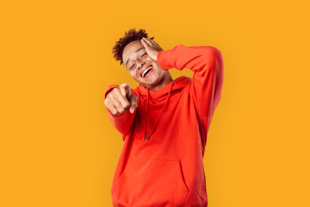 istock Young adult guy laughing and pointing at you 1270334561