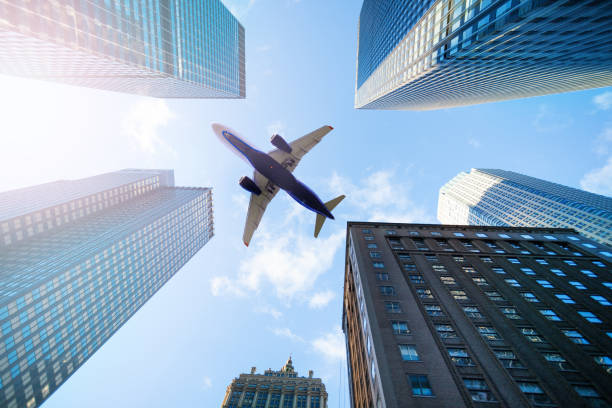 istock Commercial airplane over sky between skyscrapers 1270334623