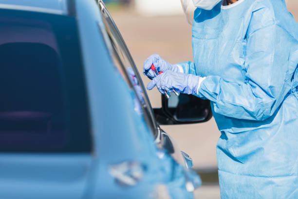 istock Female nurse holds COVID-19 test kit 1270335842