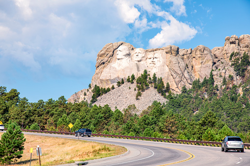 The highway leading to the Mount Rushmore National Memorial which highlights the sculpture of four American presidents carved into the mountainside located in the Black Hills of Pennington County, South Dakota.