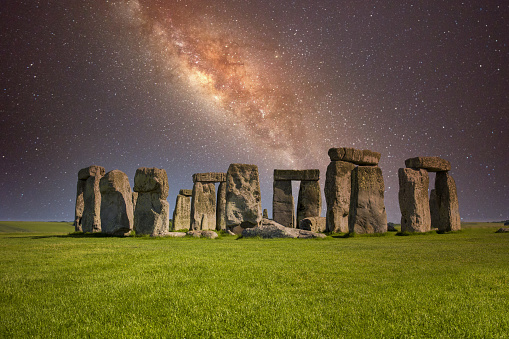 Stonehenge at night with starry milky way sky on winter solstice.