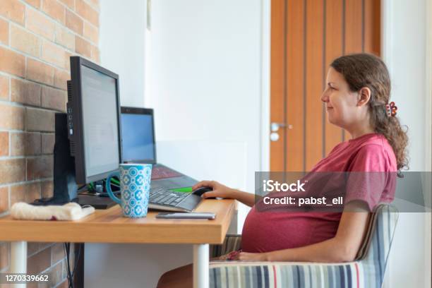 Pregnant Woman Smiling Working From Home Living Room Stock Photo - Download Image Now