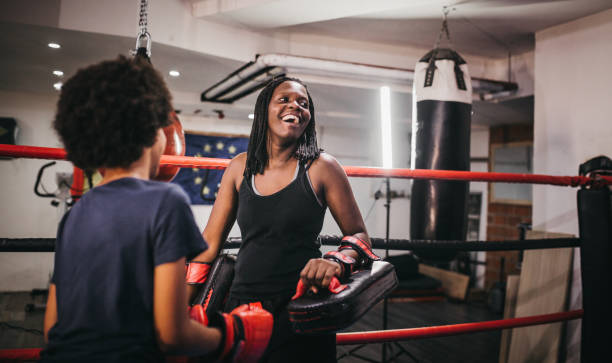 The mother teaches her daughter  boxing
