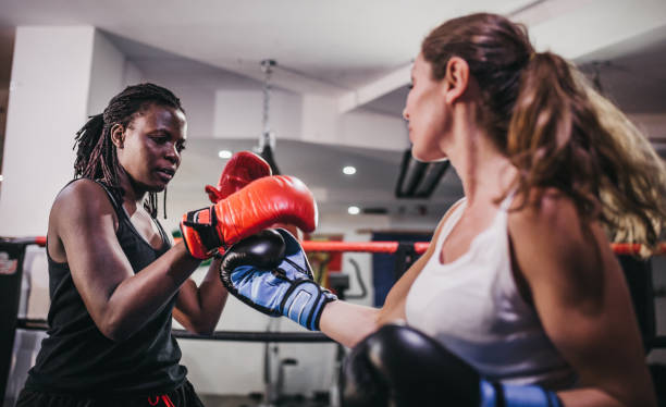 istock Female athletes fighting in boxing ring 1270343971