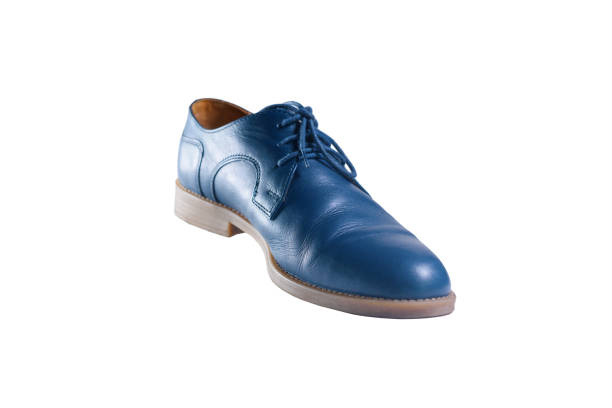 Classic dark blue leather shoes in perspective and isolated on white background without shadow. Flying of objects. Concept levitation in air.