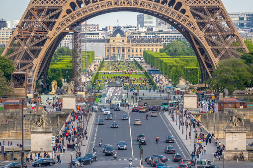 France, Paris - May 21, 2019: Eiffel Tower and Champ de Mars. Many cars and tourists on the Jena bridge