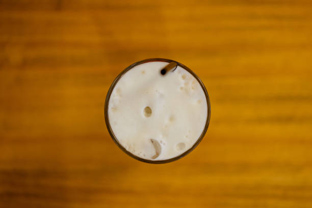 istock Frothy iced cold coffee on top of wooden table 1270356663