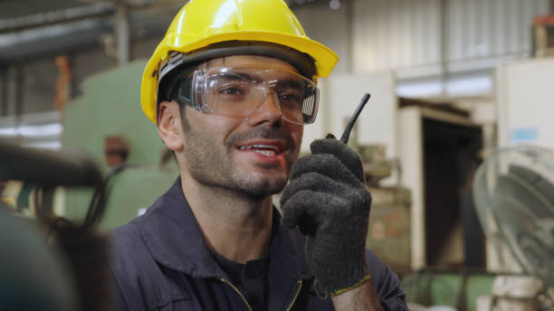 istock Factory worker talking on portable radio while inspecting machinery parts 1270356686