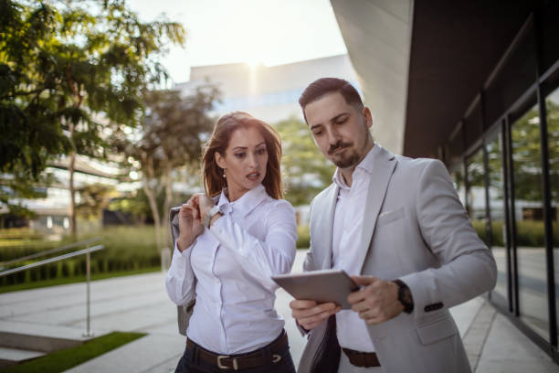 istock Young business couple standing outside office building 1270357271