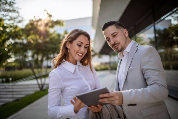 istock Young business couple standing outside office building 1270357444