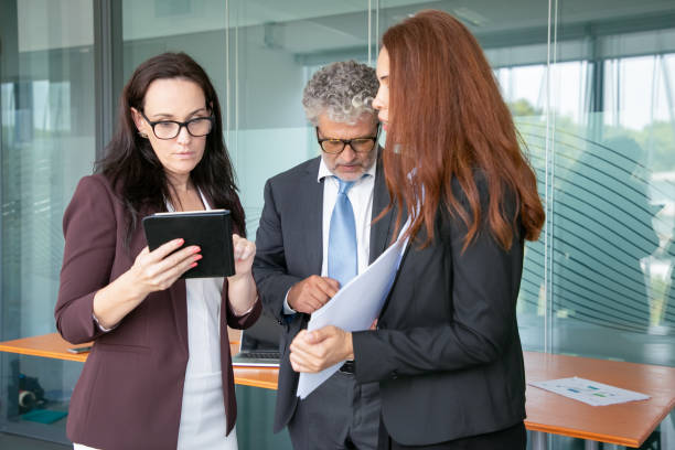 istock Experienced partners standing in office room 1270357743