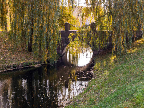 istock old stone bridge over river in autumn park 1270358468