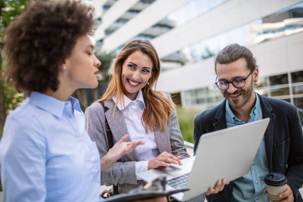 istock Young business people using s a computer outdoors 1270358597