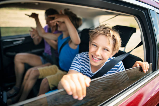 Happy kids travelling by car
