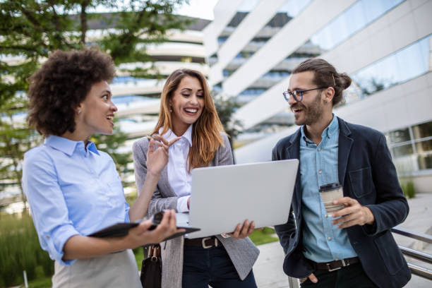 istock Young business people using s a computer outdoors 1270359294