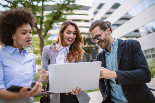 istock Young business people using s a computer outdoors 1270359346