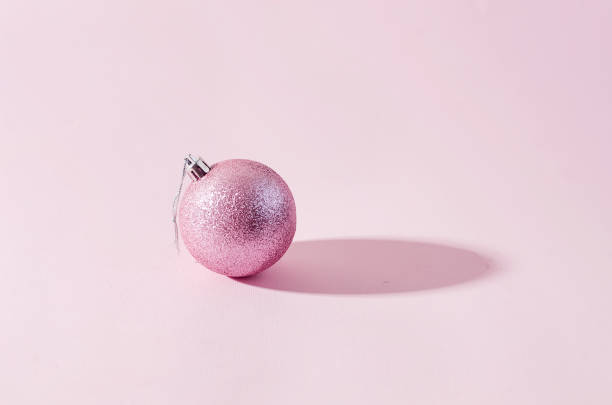 istock pink christmas balls on pink paper background 1270360504