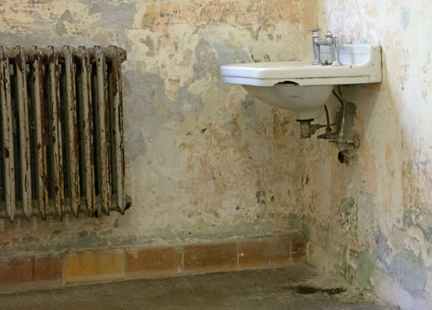 istock Old radiator and sink in an empty historic home, bathroom 1270361518