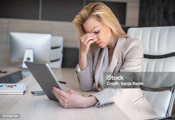 A Business Woman Sits In Her Office And Thinks About How To Solve New Problems That Have Arisen On A Project Run By Her Firm Stock Photo - Download Image Now
