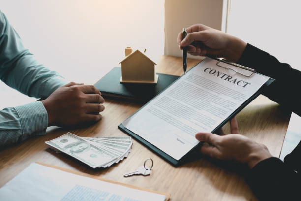 istock Agents are using pens pointing to insurance contracts and are being explained to customers at the office. 1270367687