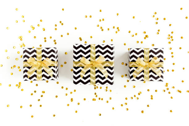 istock Gift or present boxes and stars confetti on a white background. Colorful celebration, birthday. Christmas or New Year pattern. Flat lay, top view 1270370209