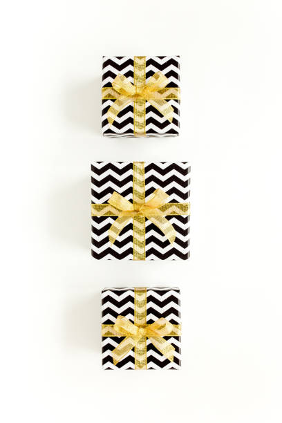 Gift or present boxes and stars confetti on a white background. Colorful celebration, birthday. Christmas or New Year pattern. Flat lay, top view