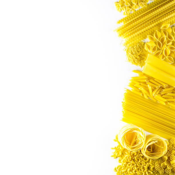 istock Raw uncooked pasta over white background. Flat lay and top view copy space for text 1270373220